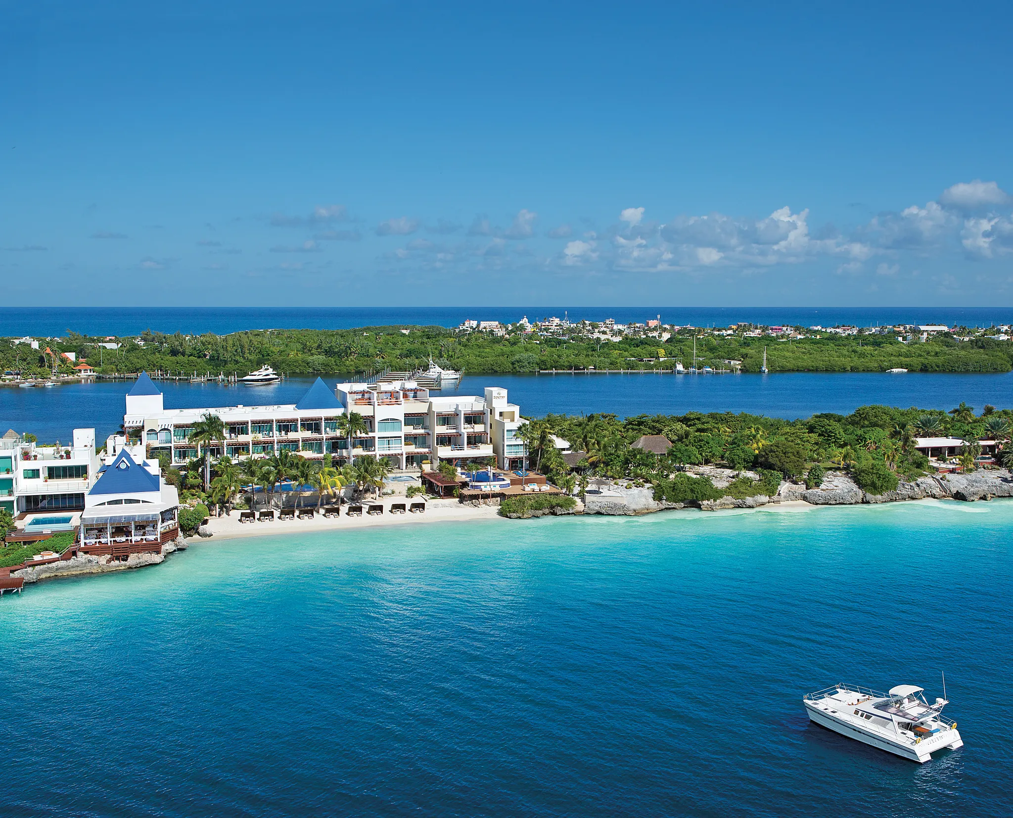 Aerial view of Zoëtry Villa Rolandi Isla Mujeres beachfront resort with turquoise waters and private shoreline.