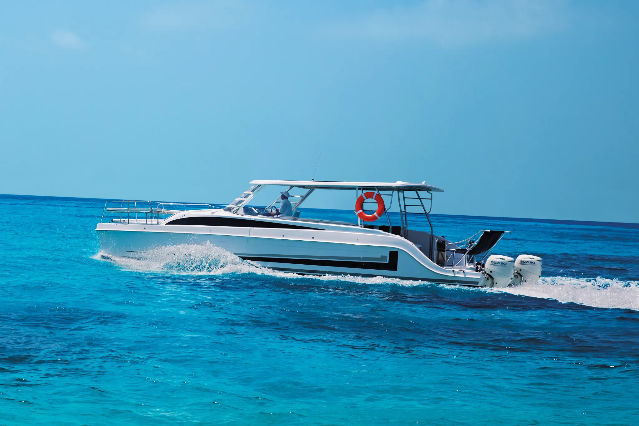Private boat transfer cruising across turquoise Caribbean waters to Zoëtry Villa Rolandi Isla Mujeres.
